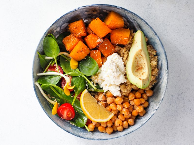 Colorful buddha bowl with avocado, chickpeas and greens