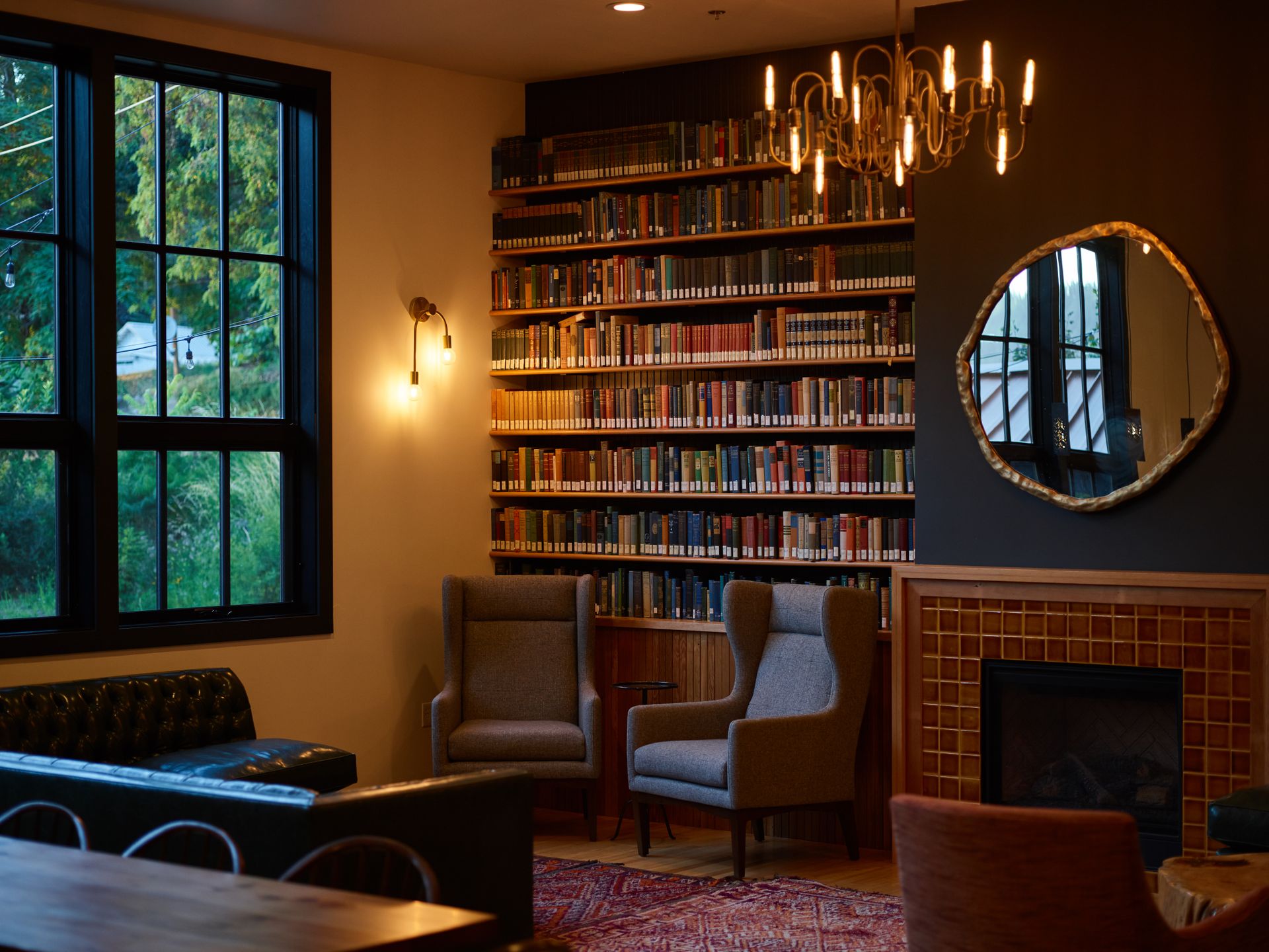 A warm, cozy interior with bookshelves and a fireplace